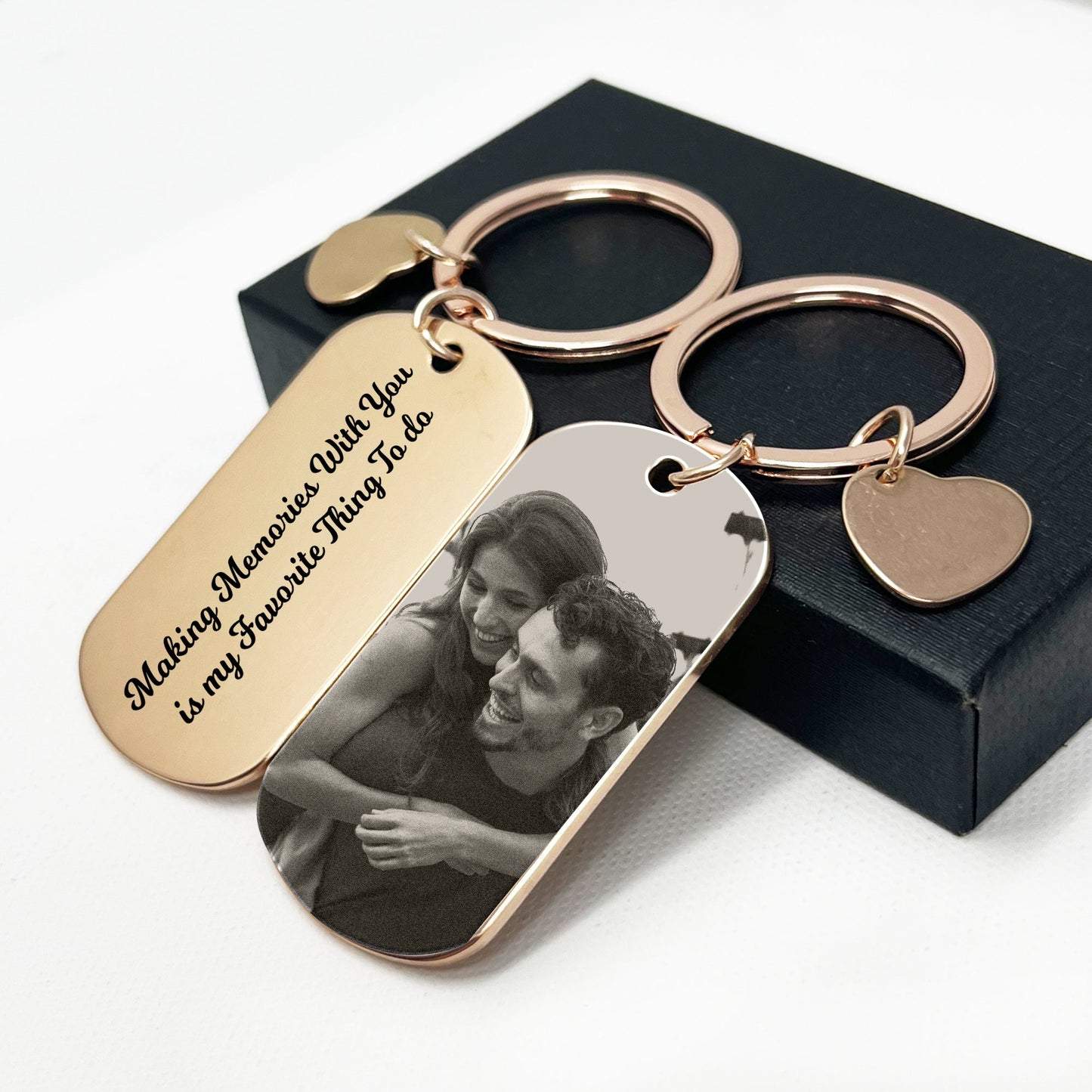 Gold keychain featuring a romantic couple motif, elegantly presented in a perfect black gift box – Ideal for special occasions