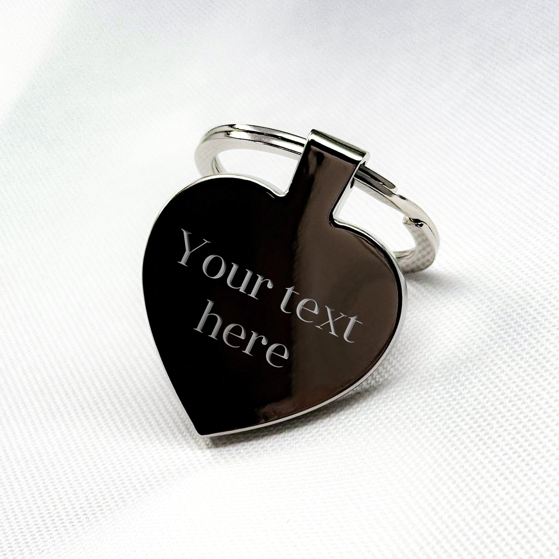 Elegant silver heart keychain featuring customizable engraving "Your text here", beautifully packaged in a premium gift box – A timeless gift