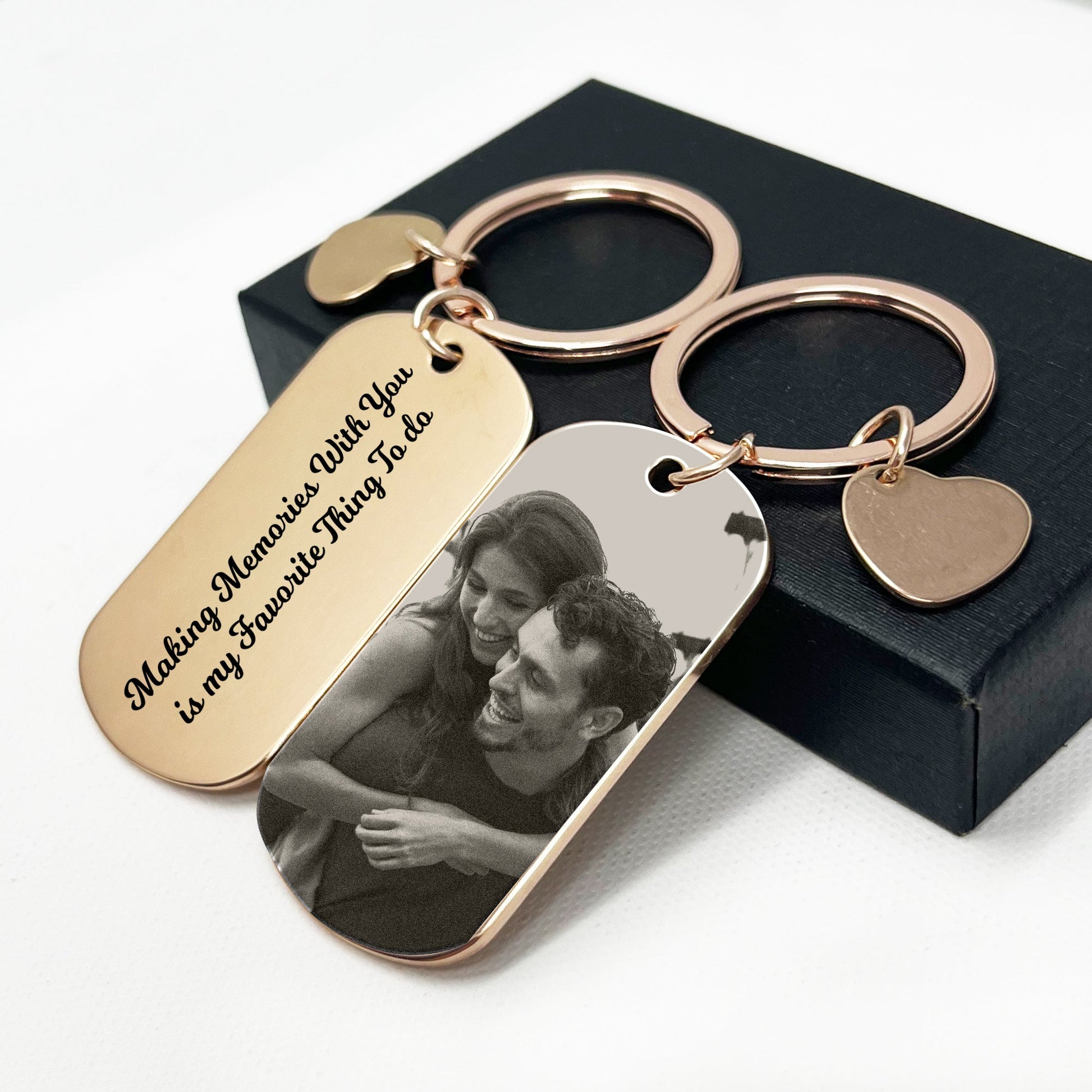 Gold keychain featuring a romantic couple motif, elegantly presented in a perfect black gift box – Ideal for special occasions